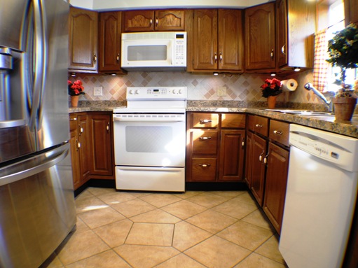 Kitchen with dishwasher, sink disposal, frig, range/oven, built-in microwave